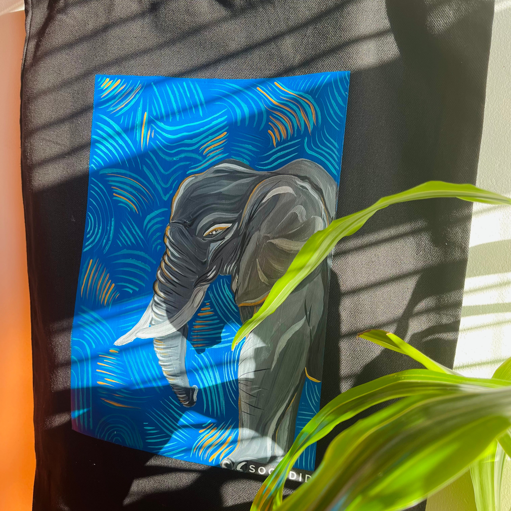 Artistic depiction of an elephant on a blue background with plant leaves in the foreground